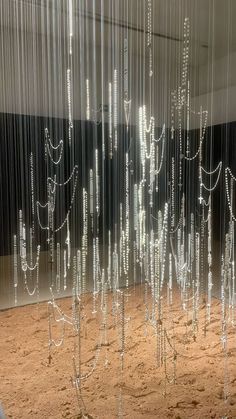 an art installation made out of glass beads and chains