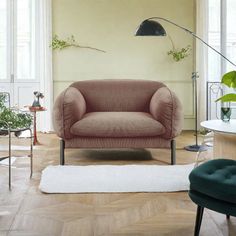 a living room filled with furniture and plants