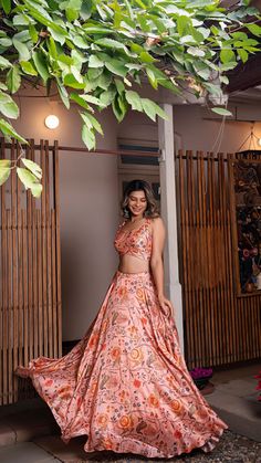 Peach raw silk printed lehenga set comes with sleeveless blouse adorned with shell and contrast thread tassels. Back closing with hook-eye opening. Color - Peach. Fabric of Lehenga + Crop Top - Printed Raw Silk. Number of components - 2. Measurements in the size chart are all garment measurements. The actual print-placement of the product may vary slightly from the image shown. Standard Lehenga Length - 43". Standard Crop Top Length - 14.5" (XS,S,M) ; 15" (L) ; 15.5" (XL) ; 16" (XXL,3XL,4XL,5XL, Pink Sleeveless Bohemian Sets, Pink Floor-length Bohemian Choli, Floor-length Pink Bohemian Choli, Pink Bohemian Floor-length Choli, Pink Bohemian Floor-length Lehenga, Bohemian Style Pink Floor-length Lehenga, Bohemian Pink Floor-length Lehenga, Summer Pink Floral Print Choli, Pink Summer Lehenga With Pallu Detail