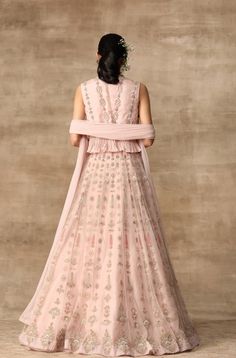 Editor's Note This set features a beautiful blush pink embroidered organza peplum top with a linear motif net lehenga and a gota embroidered net dupatta. The intricate embroidery and embellishments add a touch of elegance and glamour to the outfit, making it perfect for a special occasion such as a wedding Fabric: Net; organza; chiffon Color: Blush pink Components: Lehenga, peplum and dupatta Occasion: Engagement Disclaimer: Product color may slightly vary due to photographic lighting sources or Peplum Lehenga, Ridhi Mehra, Lehenga Dupatta, Organza Lehenga, Organza Blouse, Organza Skirt, Embroidered Crop Tops, Net Lehenga, Blouse Skirt