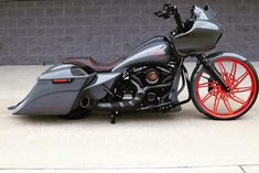 a gray and red motorcycle parked in front of a building