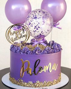 a purple birthday cake with balloons and confetti on top is shown in this image