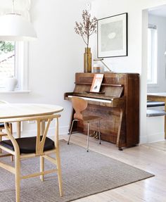 a living room filled with furniture and a piano