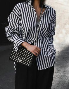 Oversized black and white white striped button down shirt.-  Button down front, pointed collar-  Oversize... Striped Button-up Shirt For Day Out, Spring Oversized Blouse With Striped Collar, Oversized Blouse With Striped Collar For Spring, Chic White Shirt With Vertical Stripes, Oversized Striped Collared Blouse, Striped Shirt For Fall Day Out, Day Out Button-up Shirt With Striped Collar, Day Out Shirt With Striped Collar Button-up, Chic Vertical Stripes Shirt For Spring