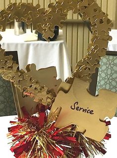 a table topped with a heart shaped sign and tinsel