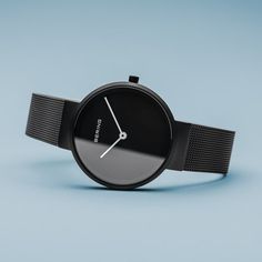 Classic, puristic, and yet exciting. Perfect style combined with contemporary minimalism. Inspired by Danish design, the CLASSIC COLLECTION represents a unique timepiece, perfectly highlighting your daily style.  The brushed black colored stainless steel case, made of pure, high quality, medical-grade stainless steel (316L), in combination with the modern black colored milanaise band, ensure the classic BERING look. A matching black colored dial, protected by crystal clear, scratch-proof sapphir Minimalist Black Watch For Formal Occasions, Modern Matte Black Watch For Formal Occasions, Modern Matte Black Formal Watch, Modern Black Everyday Watches, Sleek Black Watch For Business, Sleek Black Business Watch, Modern Black Matte Finish Watches, Matte Black Modern Quartz Watch, Modern Matte Black Quartz Watch