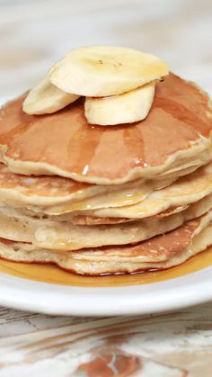 a stack of pancakes with banana slices on top