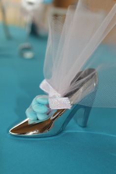 a pair of high heeled shoes sitting on top of a blue table