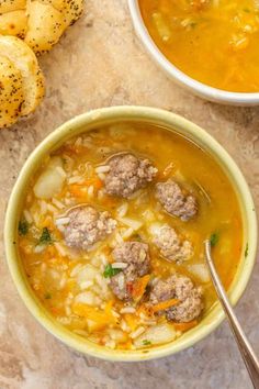 two bowls of soup with meatballs and bread on the side, next to each other