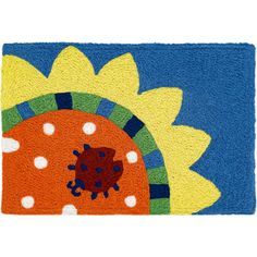 an orange and blue door mat with a sunflower on it's center piece