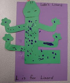 a paper cutout of a green lizard on a purple background with words like luke's lizard is for lizard