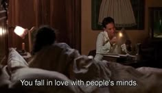 a man sitting in bed next to a woman with two candles on her face and the caption you fall in love with people's minds