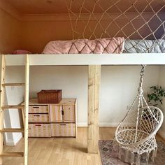 a room with a bed, chair and hammock hanging from the ceiling