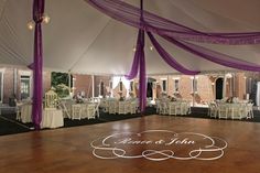 the inside of a tent with tables and chairs set up for a wedding or other function