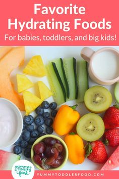 a white plate topped with fruits and vegetables next to bowls of yogurt, cucumbers, strawberries