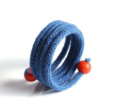 a blue ring with two orange beads on it