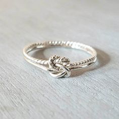 Silver double knot ring. Double knot twisted ring. Bands measure 1mm thick. Made from .925 sterling silver. Handmade in NH, USA Twisted White Gold Jewelry Gift, Silver Twisted Ring For Anniversary, Twisted Silver Rings For Anniversary, Twisted Sterling Silver Rings, North Conway Nh, Daughter Ring, Half Hitch Knot, North Conway, Wire Jewelry Rings