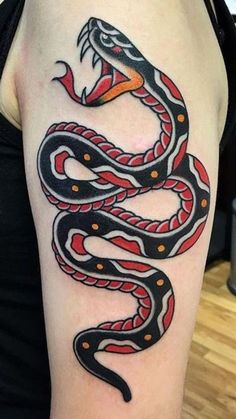 a woman's arm with a snake tattoo on it