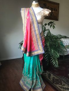 This sari is beautiful and perfect for any party. Its stunning trim, fabric, and vibrant colors make it a completely unique clothing piece. We can style any of our outfits or ones that you already own with jewelry and accessories in our collection.  We can tailor the blouse to your size or create a completely personalized blouse to your preference. Keep in mind that certain blouse styles may be cheaper or more expensive than others. If you chose to purchase the lehenga with the blouse it comes with (without any alterations) the cost with remain $150. Custom blouses and alterations will cost extra, so make sure to message me with any questions before purchasing. Green Art Silk Pre-draped Saree With Embroidered Border, Bollywood Style Multicolor Pre-draped Saree For Navratri, Bollywood Multicolor Pre-draped Saree For Navratri, Designer Green Pre-draped Saree With Embroidered Border, Bollywood Style Pre-draped Saree For Festivals, Bohemian Pre-draped Saree With Resham Embroidery For Designer Wear, Festive Green Pre-draped Saree With Embroidered Border, Bohemian Multicolor Festive Pre-draped Saree, Pink Bohemian Pre-draped Saree For Festivals