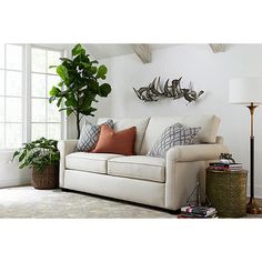 a living room filled with furniture and a potted plant