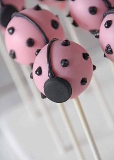 cake pops decorated with pink and black ladybugs