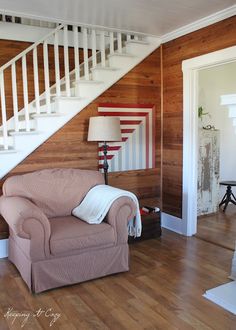 a living room filled with furniture and a stair case