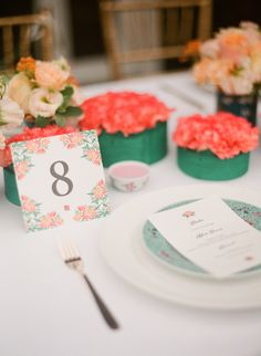 the table is set with flowers and place cards