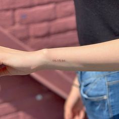 a person with a small tattoo on their arm