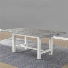 a white table sitting on top of a rug