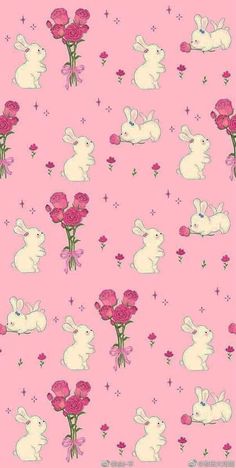 a pink background with white rabbits and flowers