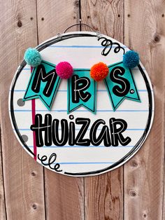 a sign that says mr and mrs houzr with pom - poms on it