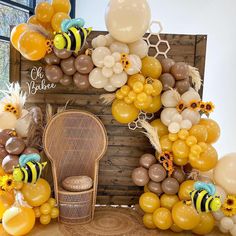 a chair sitting in front of a bunch of balloons and bees on it's back