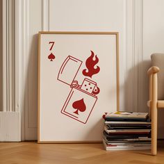 a poster with a lighter on it next to a stack of books and a chair