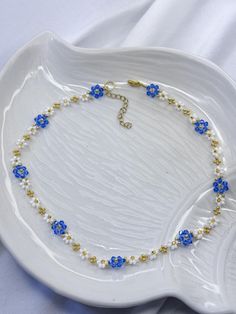 Add a touch of elegance to your ensemble with this stunning Cornflower Necklace. This dainty bead necklace features a beautiful mix of  blue and white hues, complemented by delicate daisy flower, colourful cornflowers and shimmering crystals. Perfect as a gift for her, whether it's for your wife or someone special in your life, this crystal choker necklace is sure to make a statement and add a pop of colour to any outfit. 🌺Multi functional piece - You can wrap this necklace around your wrist to Flower Bead Choker, Blue Flower-shaped Beaded Necklace With Tiny Beads, Blue Flower Necklace With Tiny Beads, Daisy Bead Necklace, Light Blue Necklace, Beads Design, Crystal Choker Necklace, Crystal Choker, Necklace Crystal