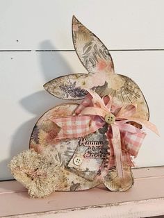 a wooden bunny sitting on top of a shelf