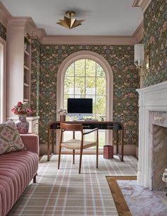 a living room filled with furniture and a fire place in front of a tv mounted on a wall