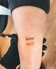 a person with the word why not written on their leg