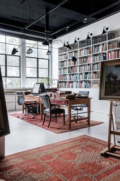 a large room with many bookshelves and tables