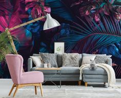 a living room with a couch, chair and wallpaper that has palm leaves on it