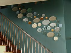 plates are arranged on the wall next to stairs