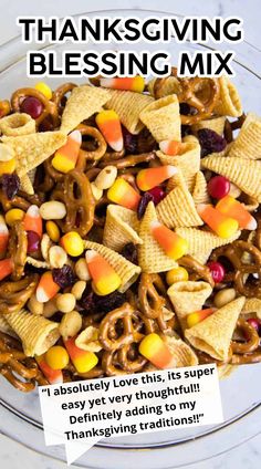 a glass bowl filled with cornflakes, candy bars and pretzels for thanksgiving