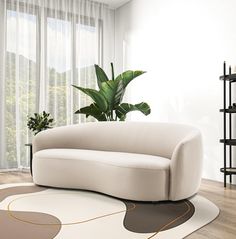 a white couch sitting on top of a hard wood floor next to a potted plant