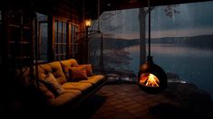 a couch sitting in front of a fire place on top of a wooden floor next to a window