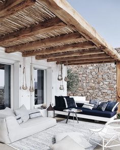 a living room filled with furniture and stone walls