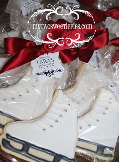 decorated cookies in the shape of ice skates with red ribbon and bow on top