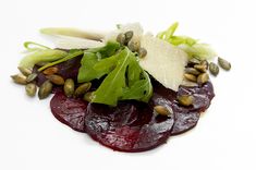 beet salad on white plate with garnish and seeds