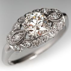 an antique style diamond ring on a white background