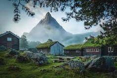 an image of some houses in the mountains with grass on their roofs and green roof tops