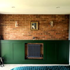 a room with a brick wall and radiator