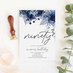 a white card with blue flowers and the word ninety on it